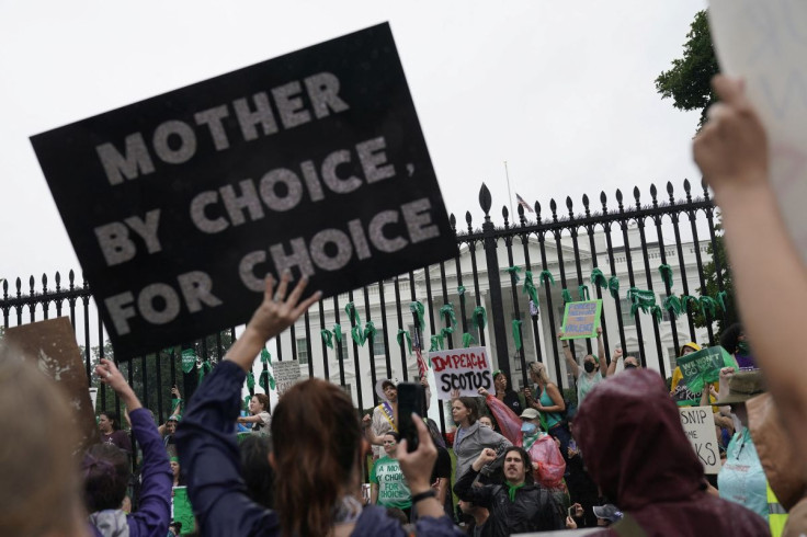 Women's March activists hold signs outside the White House in the wake of the U.S. Supreme Court's decision to overturn the landmark Roe v Wade abortion decision in Washington, D.C., U.S., July 9, 2022. 