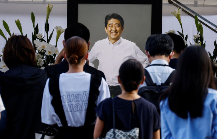 People lay flowers on a flower offering at Abe at Zojoji Temple, where the vigil and funeral of late former Japanese Prime Minister Shinzo Abe, who was shot while campaigning for a parliamentary election, will be held, in Tokyo, Japan July 11, 2022.