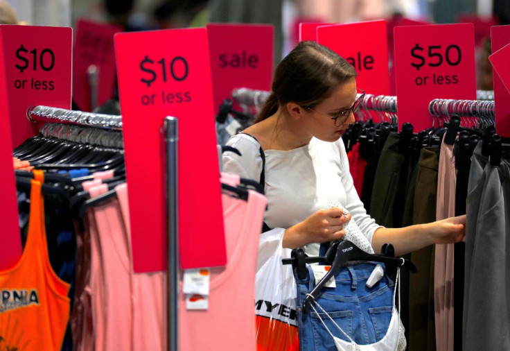 A shopper holds items and looks at others on sale at a clothing retail store in central Sydney, Australia, March 19, 2017. 