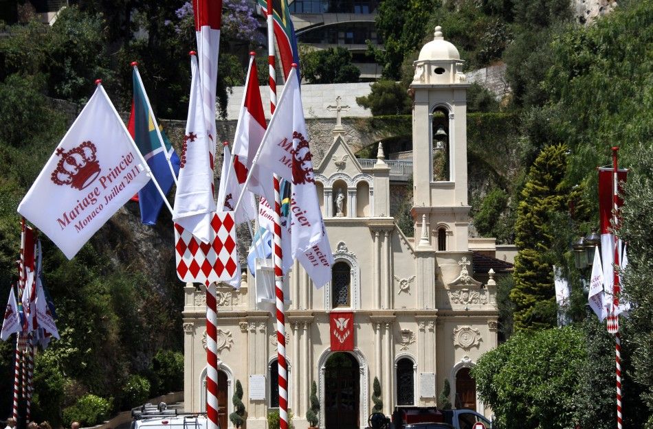 A flag announcing the upcoming Royal wedding is seen outside the Sainte Devote church in Monaco
