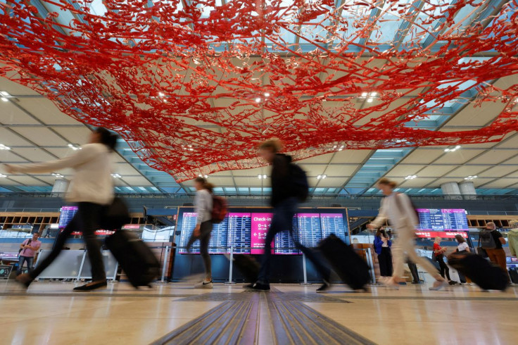 Passengers walk at Berlin Brandenburg Airport (BER), in Schoenefeld near Berlin, Germany, July 7, 2022.