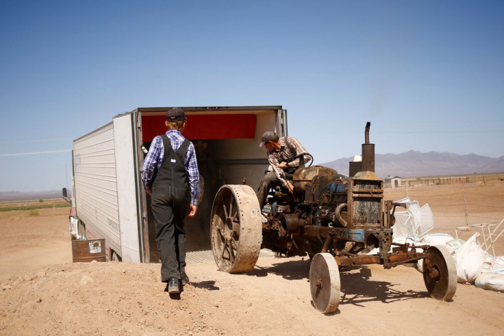 Wilhelm Harder, backs his father's old tractor into a truck as he prepares to leave Chihuahua and move to Campeche state in search of new land to farm, in the Mennonite community of El Sabinal, Chihuahua, Mexico, April 24, 2021.  