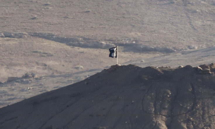 A black flag belonging to the Islamic State is seen near the Syrian town of Kobani, as pictured from the Turkish-Syrian border near the southeastern town of Suruc in Sanliurfa province, October 6, 2014.