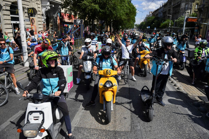 Delivery workers take part in a protest on the Margaret Bridge against a move by the Hungarian government to tighten a favourable tax rate offered to small businesses, in Budapest, Hungary July 12, 2022.