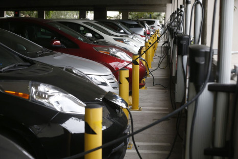 Electric cars sit charging in a parking garage at the University of California, Irvine January 26, 2015.   