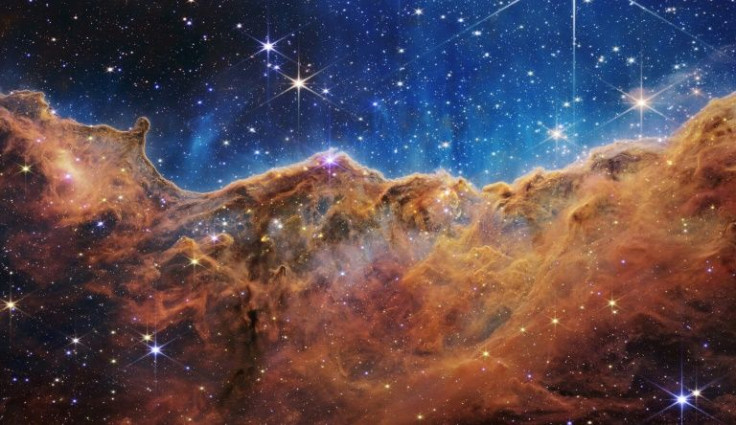 This image from the James Webb Space Telescope shows âmountainsâ and âvalleysâ speckled with glittering stars which is actually the edge of a nearby, young, star-forming region called NGC 3324 in the Carina Nebula
