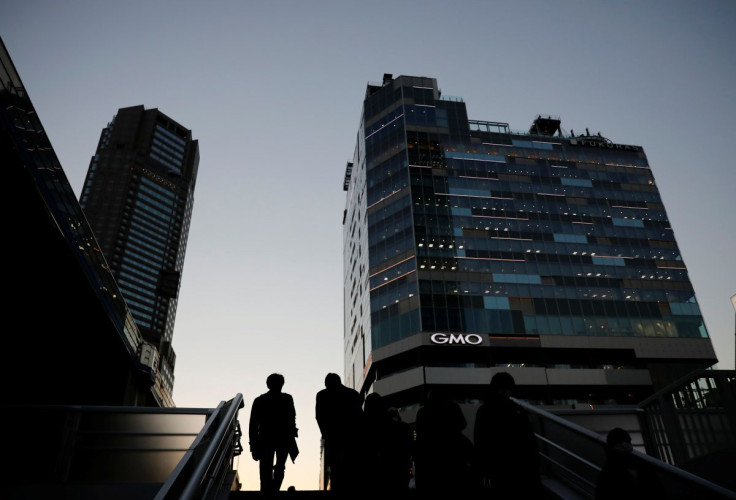 Pedestrians make their way at a business district in Tokyo, Japan, December 7, 2020. 