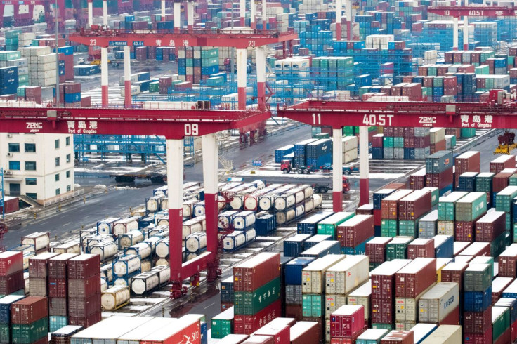 Containers and trucks are seen following a snowfall at the port of Qingdao, Shandong province, China February 14, 2019.