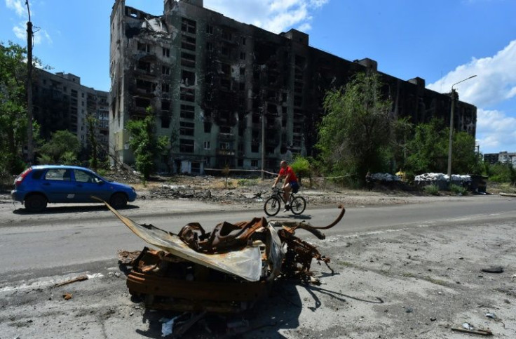 In the city's surroundings, apartment buildings with blackened facades were riddled with large holes