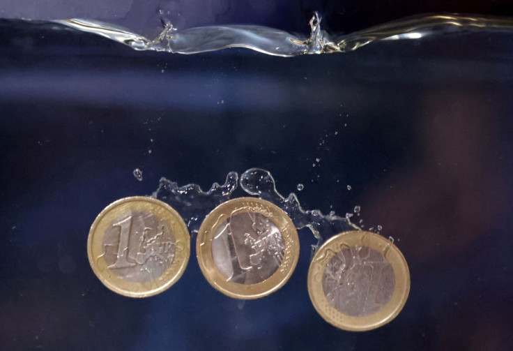 Euro coins plunge into water in this illustration taken, May 23, 2022. 