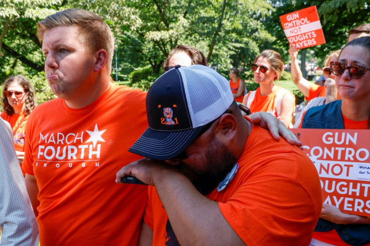 A fellow rally-goer consoles Javier Cazares, whose daughter Jacklyn Cazares was killed in the mass shooting at Robb Elementary School in Uvalde, Texas, during the March Fourth rally against assault weapons on Capitol Hill in Washington, U.S., July 13, 202