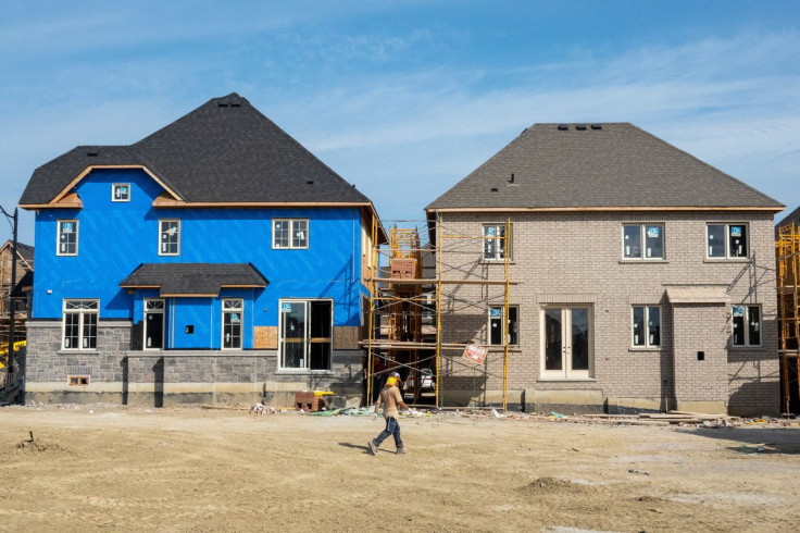 A construction crew walks in front of new homes under construction, on the day Bank of Canada increased its policy rate a full percentage point in Brampton, Ontario, Canada July 13, 2022. 
