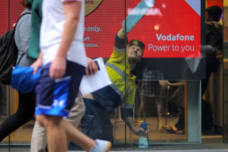 A worker cleans the window of a telecommunications retail store in central Sydney, Australia, June 16, 2017. 