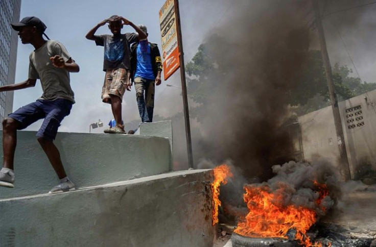 Haitians protesting high prices and shortages burn tires on a street of Port-au-Prince on July 13, 2022