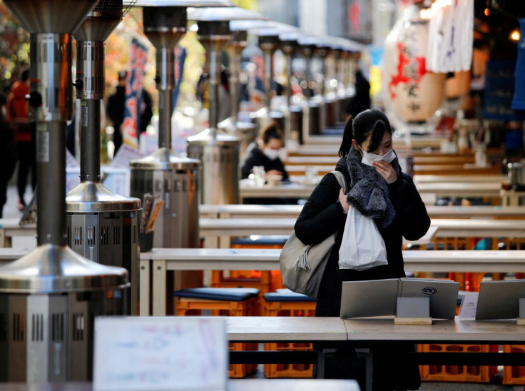 A woman wearing protective a face mask is seen at an open-air restaurant as the government declared the second state of emergency for the capital and some prefectures, amid coronavirus disease (COVID-19) outbreak, in Tokyo, Japan January 9, 2021. 