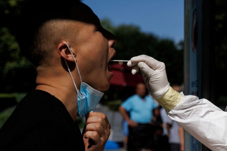 A man gets a swab test at a nucleic acid testing station, following a coronavirus disease (COVID-19) outbreak, in Beijing, China, July 14, 2022. 