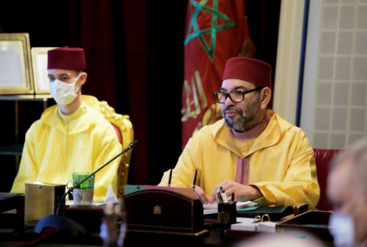 Morocco's King Mohammed VI (R) chairs the council of ministers meeting, accompanied by his son Crown Prince Moulay El Hassan, during which the monarch authorised a reorganisation of the kingdom's Jewish community
