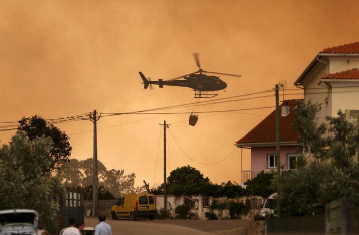 A fire fighting helicopter works to contain a wildfire in Leiria, Portugal July 13, 2022. 