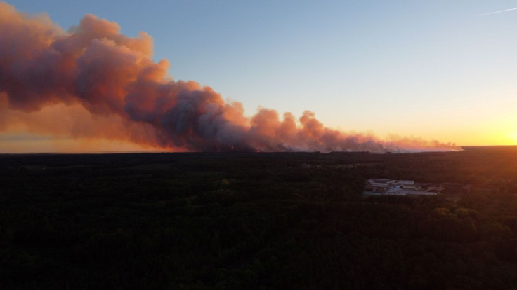 A view shows smoke rising from the Gironde forest fires as seen from Landiras, France July 12, 2022 in this picture obtained from social media. Twitter @Dgamax/via REUTERS