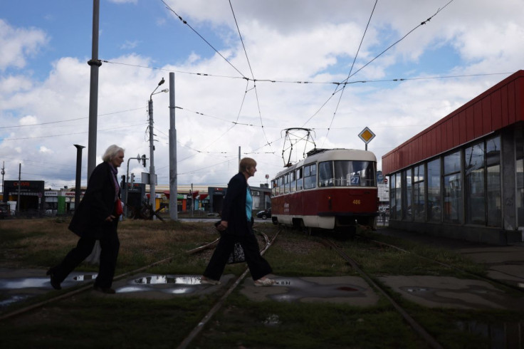 Women walk across tram tracks in Saltivka, a Soviet-era, working-class district of Kharkiv that took the brunt of heavy artillery shelling, as its tram service restarted amid Russia's invasion of Ukraine, in Kharkiv, Ukraine July 14, 2022.