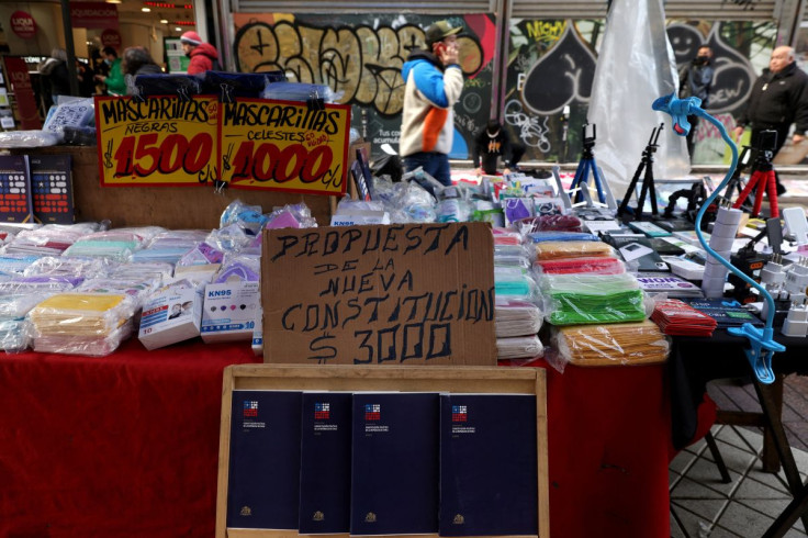 Books of proposed new constitution are displayed at a hawker's street stall at downtown Santiago, Chile July 14, 2022. The sign reads 'Proposal of new constitution' .