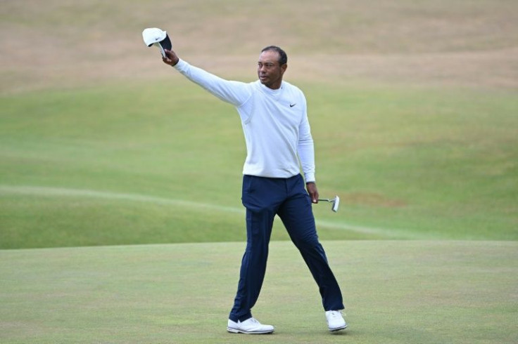 Tiger Woods gestures to the crowd on the 18th green at the end of his second round