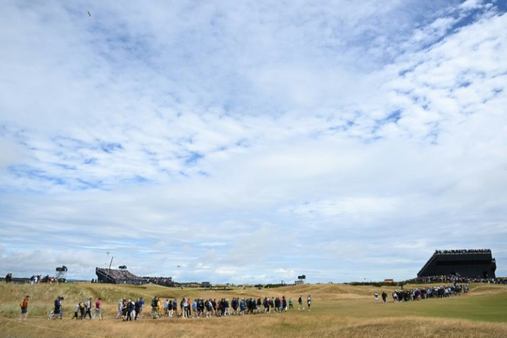 Spectators cross the 12th fairway at St Andrews