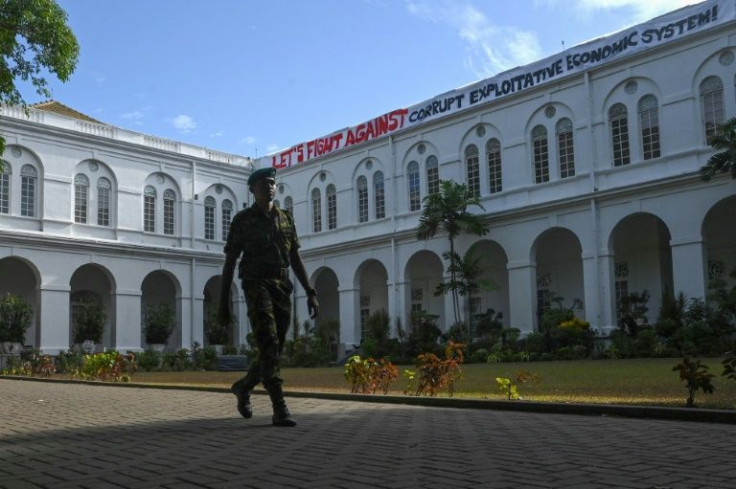 A cadet walks in front of the Sri Lankan presidentâs official residence on Friday after it was overrun by protesters last weekend