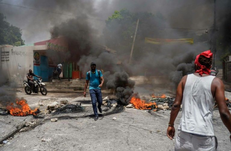 Haitians protesting high prices and fuel shortages burn tyres on a street of Port-au-Prince on July 13, 2022
