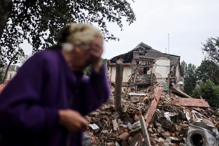 Raisa Shapoval, 83, cries in front of the site of a military strike in Chuhuiv, about 6 km from the frontline, amid Russia's invasion of Ukraine, in Kharkiv region, Ukraine July 16, 2022. 