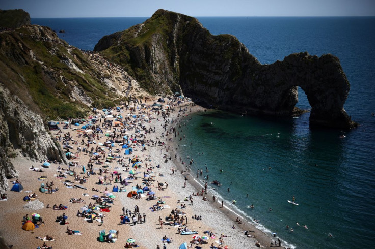 People relax on Durdle Door Beach during warm weather, in Dorset, Britain, July 16, 2022. 