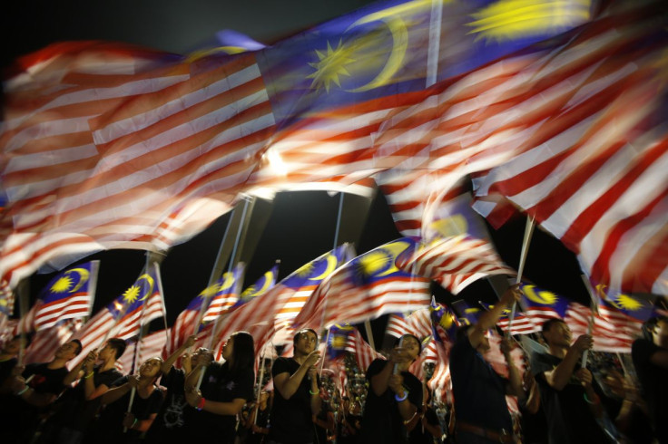 Locals from Sabah wave Malaysian flags during the Malaysia Day celebrations marking Sabah's entry into Malaysia, in Kota Kinabalu September 16, 2012. With a general election due within seven months, the 13-party ruling Barisan Nasional coalition is bankin