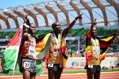 Gold medallist Uganda's Joshua Cheptegei (C), silver medallist Stanley Waithaka Mburu of Kenya (L) and bronze medallist Jacob Kiplimo of Uganda (R)
