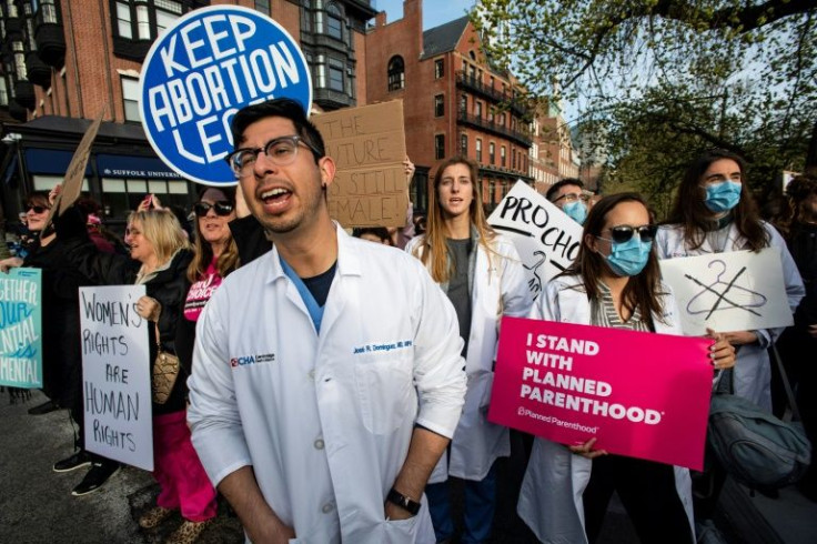 A group of doctors and medical workers join protesters gathering in front of the State House in Boston to show support and rally for abortion rights -- penalties if doctors violate some of the new laws in place to restrict the procedure can be severe