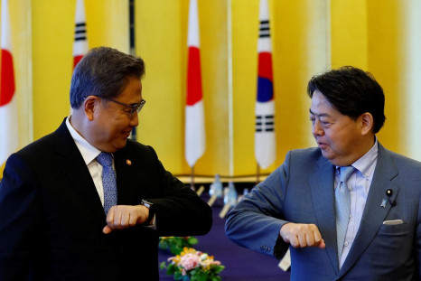 South Korean Foreign Minister Park Jin and Japanese counterpart Yoshimasa Hayashi bump elbows before their talks, in Tokyo, Japan, July 18, 2022. 