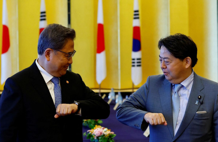 South Korean Foreign Minister Park Jin and Japanese counterpart Yoshimasa Hayashi bump elbows before their talks, in Tokyo, Japan, July 18, 2022. 