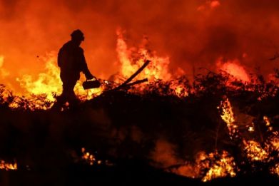 Fires in France, Greece, Portugal and Spain force thousands of residents and tourists to flee and kill several people