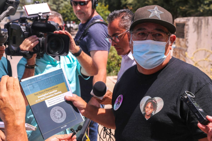 Vicente Salazar, grandfather of Layla Salazar, a victim of the Uvalde mass shooting, holds up a copy of a preliminary report from the special House investigative commitee on the mass shooting at Robb Elementary in Uvlade, Texas, U.S. July 17, 2022. Aaron