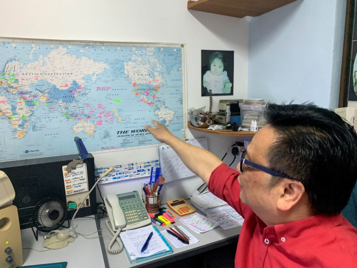 Kelvin Pang, a Singapore-based electronics broker, points to a map in his office in Singapore, June 24, 2022.