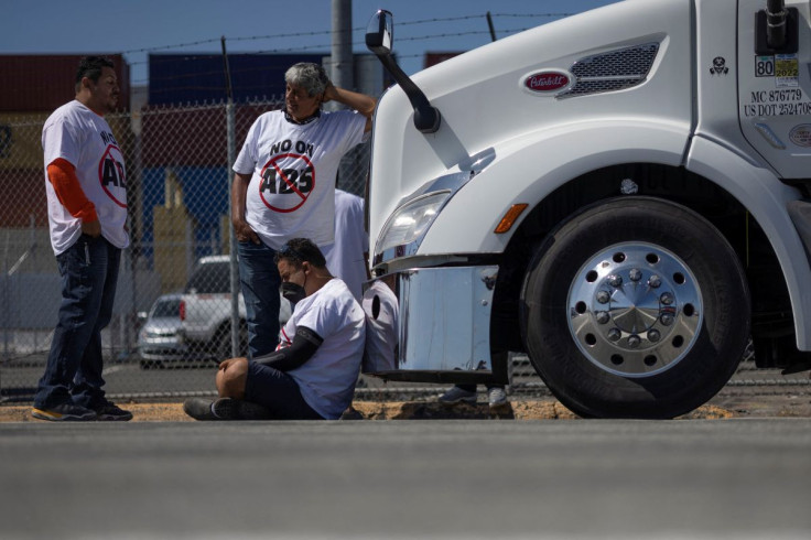 Independent truck drivers gather to delay the entry of trucks at a container terminal at the Port of Oakland, during a protest against California's law known as AB5, in Oakland, California, July 18, 2022. 