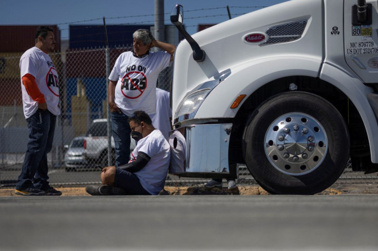 Independent truck drivers gather to delay the entry of trucks at a container terminal at the Port of Oakland, during a protest against California's law known as AB5, in Oakland, California, July 18, 2022.