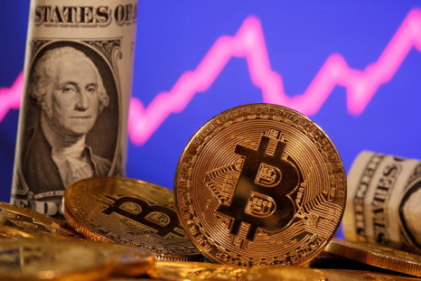 A representation of virtual currency bitcoin and a U.S. one dollar banknote are seen in front of a stock graph in this illustration taken January 8, 2021. 