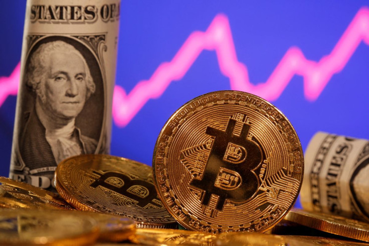A representation of virtual currency bitcoin and a U.S. one dollar banknote are seen in front of a stock graph in this illustration taken January 8, 2021. 