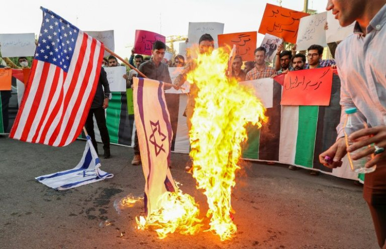 Iranian students burn US and Israeli flags on July 16 during a protest against the visit of US President Joe Biden to Israel and Saudi Arabia