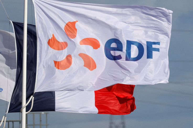 A flag with the company logo of Electricite de France (EDF) and a French flag fly next to the EDF power plant in Bouchain, near Valenciennes, France, September 29, 2021.