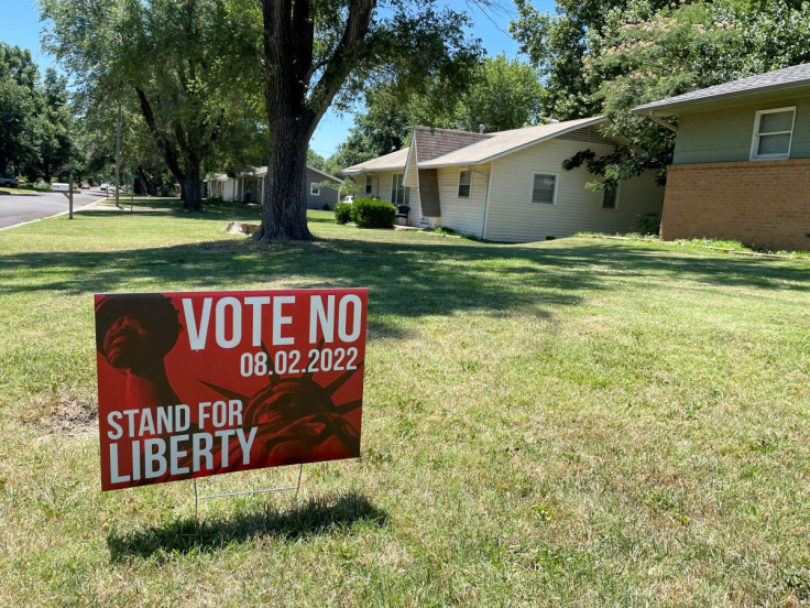 Yard signs in urge residents to vote on an amendment to Kansas' constitution that would assert there is no right to abortion, in Wichita, Kansas, U.S., July 10, 2022. 