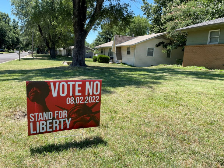 Yard signs in urge residents to vote on an amendment to Kansas' constitution that would assert there is no right to abortion, in Wichita, Kansas, U.S., July 10, 2022.