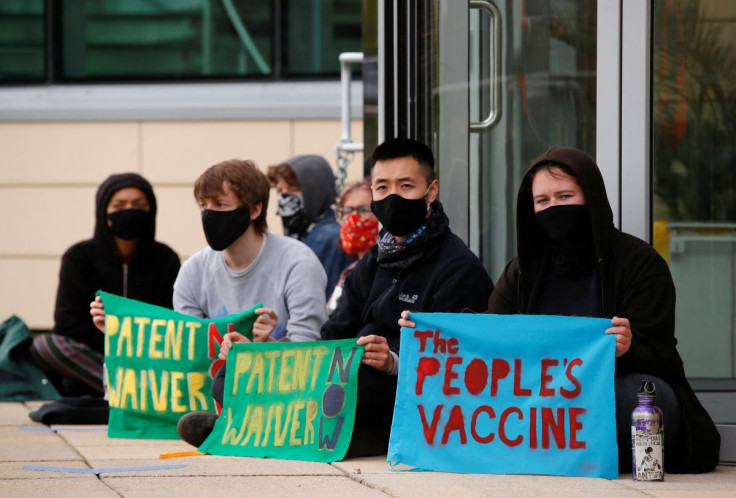 Protesters display banners against vaccine patents outside the Cambridge AstraZeneca site, amid the coronavirus disease (COVID-19) pandemic, in Cambridge, Britain, May 11, 2021.