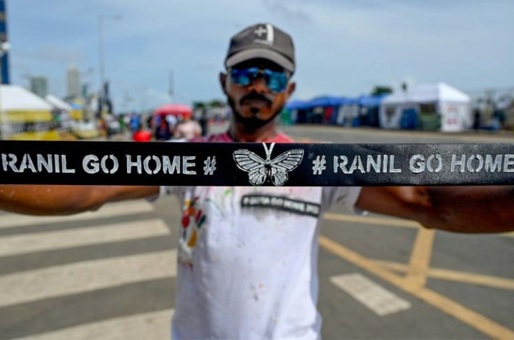 A demonstrator displays a headband with a slogan against interim Sri Lankan President Ranil Wickremesinghe during a demonstration near the Presidential secretariat in Colombo on July 17, 2022.