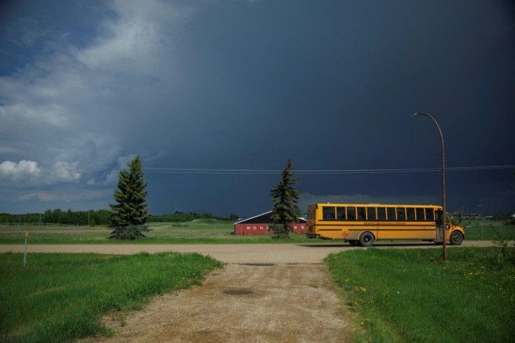 A yellow school bus on June 7 passes an empty lot where the Ermineskin Indian Residential School once stood in the Indigenous community of Maskwacis, Alberta. Pope Francis' end of July visit to Canada in which he is to offer apologies for more than a cent